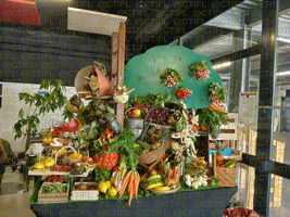 Théâtralisation du rayon fruits et légumes, corbeilles de fruits et sculptures 